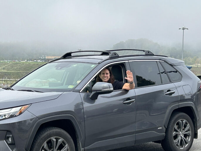 A photograph of Dr. Shogan in her car on the road visiting National Archives facitilies.