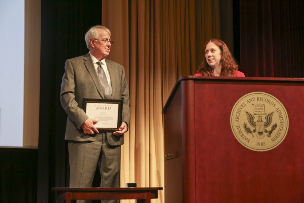 On May 9, 2024, Dr. Shogan (right) attended the Archivist's Achievement Awards, where she presented the Weidman Award to Harry S. Truman Presidential Library volunteer James U'Ren (left). National Archives photo by Susana Raab.