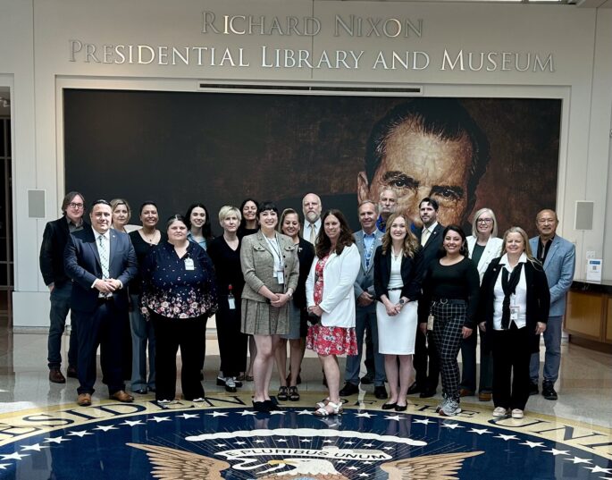 Dr. Shogan poses with staff at the Richard Nixon Presidential Library.