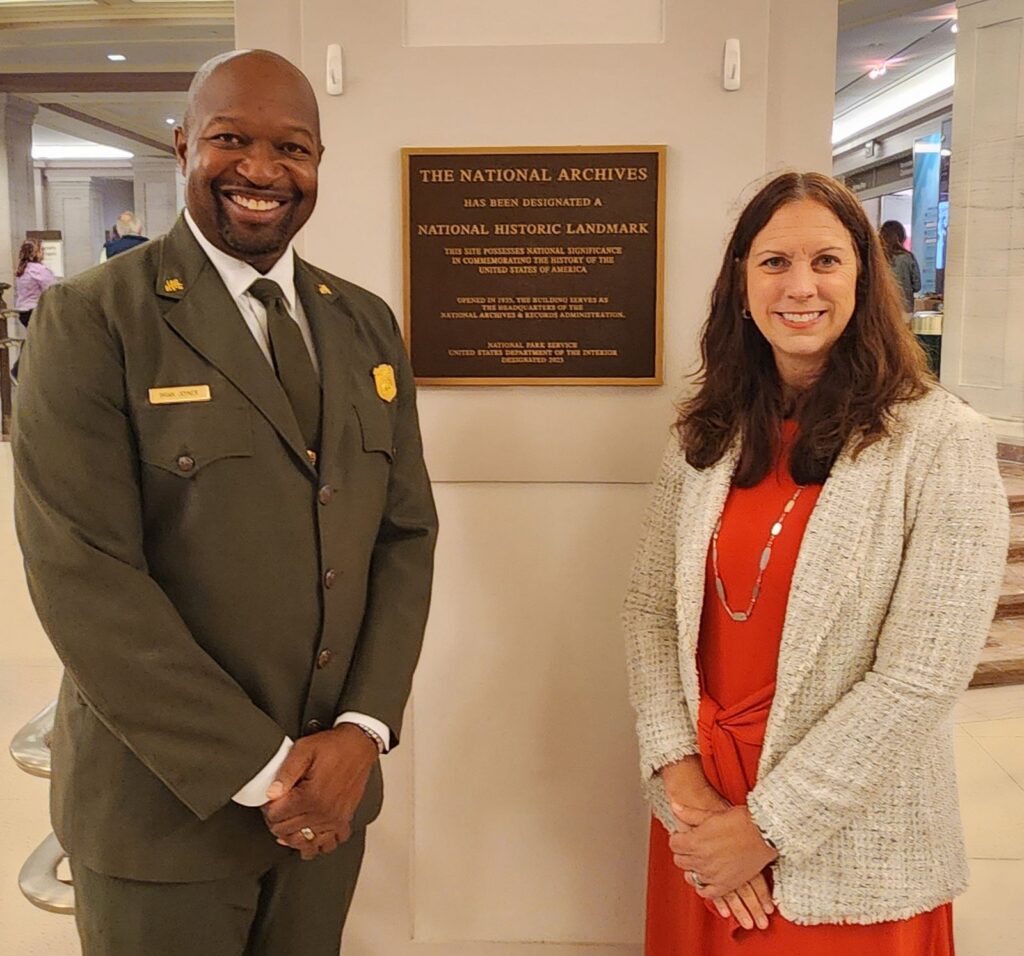 Dr. Shogan and acting superintendent of Rock Creek Park Brian Joyner stand in front of the newly installed National Archives Building Historic Landmark plaque.