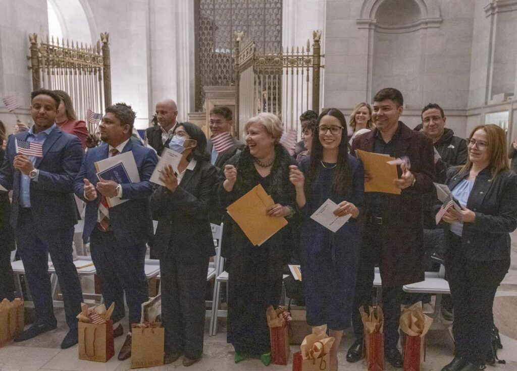 Newly naturalized citizens celebrate in the Rotunda of the National Archives, December 13, 2024 during a special event in celebration of Bill of Rights Day. (National Archives photo by Susana Raab)