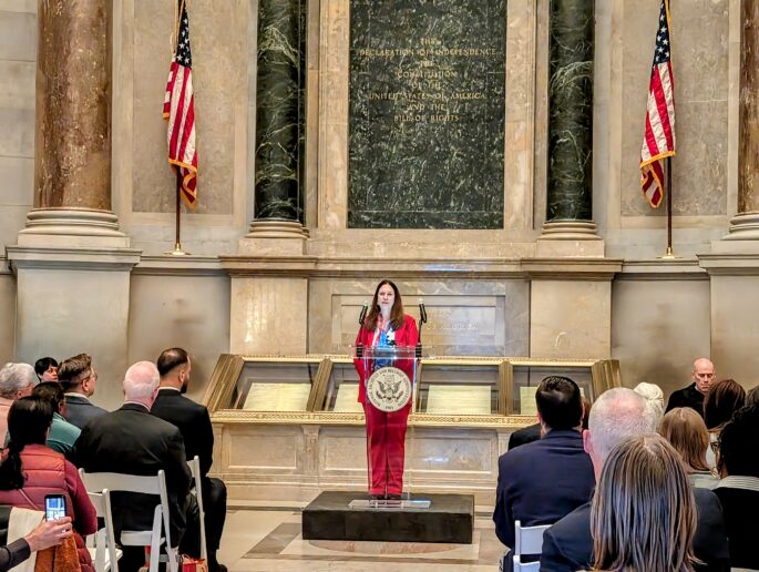 Dr. Shogan providing remarks at the December 13 naturalization ceremony at the National Archives